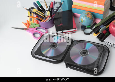 stack of CDs and school supplies isolated on white background.photo with copy space Stock Photo