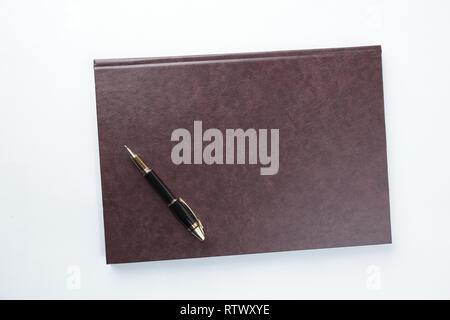 organizer in leather cover and pen on white background.photo with copy space Stock Photo
