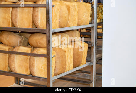 A lot of ready-made fresh bread in a bakery oven in a bakery. Bread making  business Stock Photo - Alamy