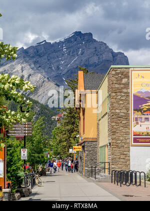 Banff Avenue shops and tourists on June 19, 2015 in Banff National Park, Alberta, Canada. Banff Avenue is the central shopping district in the town o Stock Photo