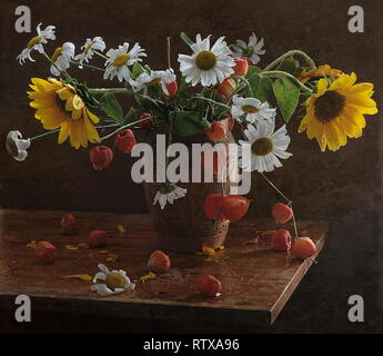 Still life with decorative sunflowers and daisies in a white jug Stock Photo