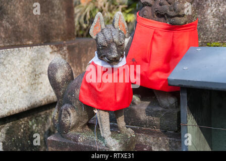 Statue of fox at Fushimi Inari Taisha in Kyoto. Foxes or kitsune in Japanese are regarded as messengers from heaven. Stock Photo