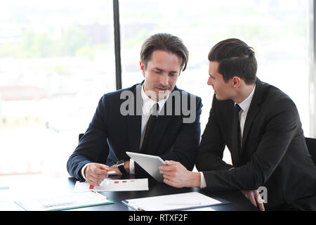 Business people using tablet pc together at office Stock Photo