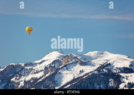 Altach, Vorarlberg, Austria - Februar 10, 2019: Hot air balloon flying over Appenzell Alps from Rhine Valley near Bregenz, Switzerland