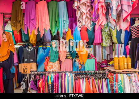 textile stall with muslim head wear and fabrics in Kuala Lumpur street market Malaysia Stock Photo