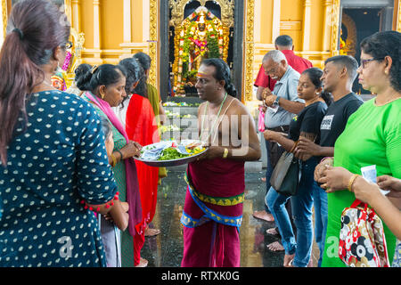 Hindu Priest Receiving Donations in front of Sri Venkatesha Perumal Shrine, Kuil Sri Krishna Hindu Temple, Kuala Lumpur, Malaysia. Stock Photo