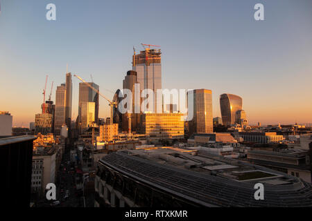 A dramatic City of London skyline with the high rise buildings bathed in golden light Stock Photo