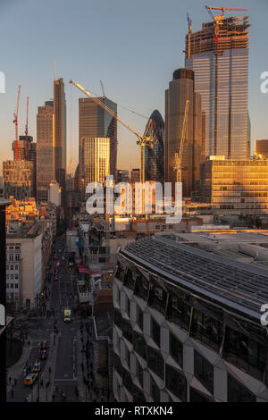 A dramatic City of London skyline with the high rise buildings bathed in golden light Stock Photo