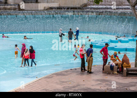 Malaysians in Swimming Pool, KLCC Park, Kuala Lumpur, Malaysia. Stock Photo