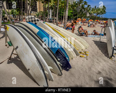 Surfboard rentals waiting for tourists on Waikiki beach on April 29, 2014 in Oahu. Waikiki beach is beachfront neighborhood of Honolulu, best known fo Stock Photo