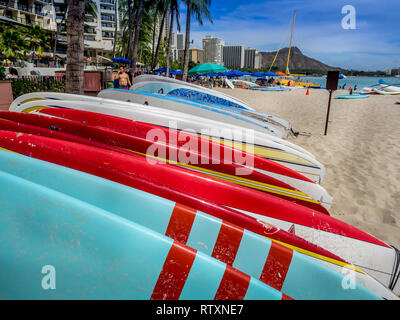 Surfboard rentals waiting for tourists on Waikiki beach on April 29, 2014 in Oahu. Waikiki beach is beachfront neighborhood of Honolulu, best known fo Stock Photo