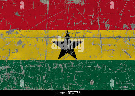 Grunge Ghana flag on old scratched wooden surface. National vintage background. Stock Photo