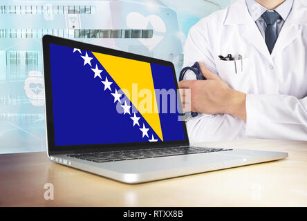 Bosnia Herzegovina healthcare system in tech theme. Bosnian flag on computer screen. Doctor standing with stethoscope in hospital. Cryptocurrency and  Stock Photo