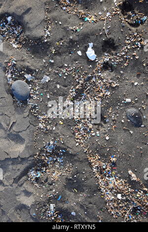 Small plastic parts and microplastics in the sand of Famara beach, Lanzarote, Spain. Stock Photo