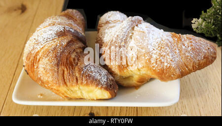 Traditional Italian breakfast, Italian brioches on white plate Stock Photo