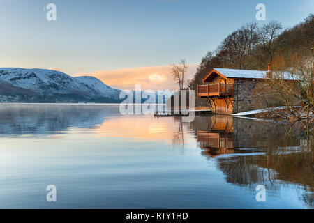 Sunrise at the old boathouse at Pooley Bridge on the shores of Ullswater in the Lake District in Cumbria Stock Photo