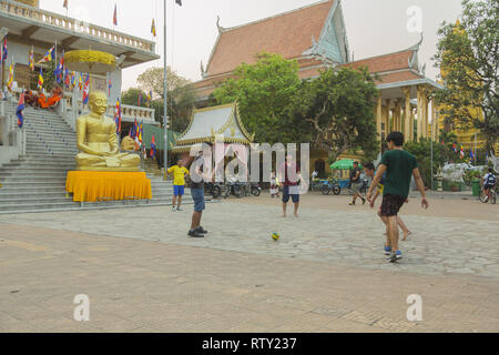 Kids play soccer at Wat Ounalom temple in Phnom Penh Stock Photo