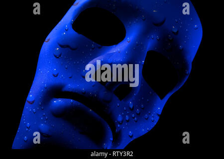 Blank robot face with blue water texture for skin. AI concept with close up human like features. Black background. Stock Photo