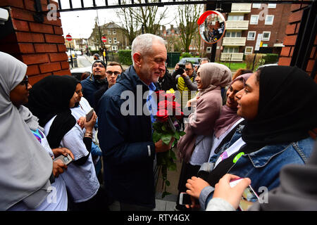 Labour Party leader Jeremy Corbyn is greeted as he arrives at the Finsbury Park Mosque in north London, on the 10th annual Visit My Mosque Day, part of an initiative by the Muslim Council of Britain (MCB). Stock Photo