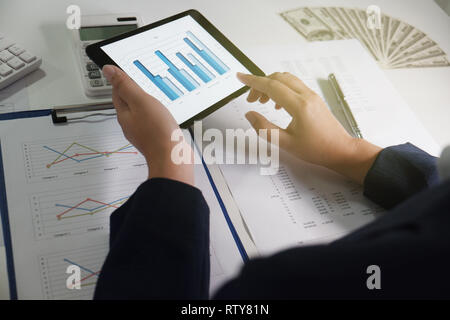 Women working in office. financial analysis with charts on pad for business, accounting, insurance or finance concept Stock Photo