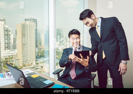Two businessmen looking at digital tablet Stock Photo