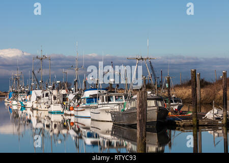 Commercial fishing boats docked in a narrow tidal inlet called Scotch Pond near Steveston British Columbia Stock Photo
