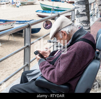 Elderly man using mobile phone Stock Photo