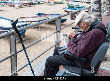 Elderly man using mobile phone Stock Photo
