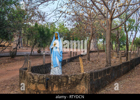 A beautiful statue of Ave Maria in a garden full of trees near the coastal town of Elmina, Ghana, West Africa Stock Photo