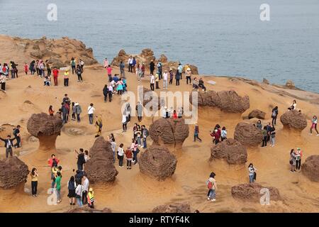 YEHLIU, TAIWAN - NOVEMBER 24, 2018: People visit Yehliu Geopark in Taiwan. Yehliu is a popular tourism destination with peculiar natural rock forms. Stock Photo