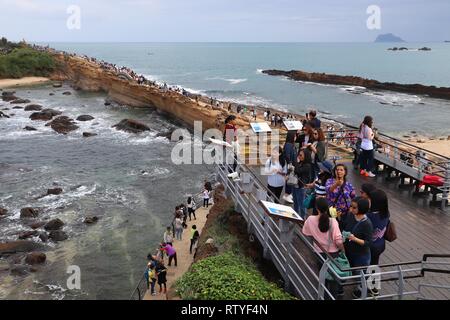 YEHLIU, TAIWAN - NOVEMBER 24, 2018: People visit Yehliu Geopark in Taiwan. Yehliu is a popular tourism destination with peculiar natural rock forms. Stock Photo