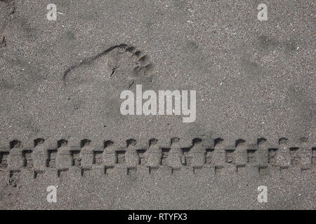 Man's footprint and rim footprint, marks in the sand Stock Photo