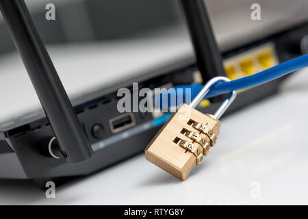 Network and data protection concept with padlock. Internet router or switch with cable plugged in. Stock Photo