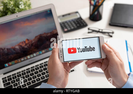 Wroclaw, Poland - JAN 31, 2019: Man holding smartphone with Youtube logo. Youtube is most popular video service developed by Google Stock Photo