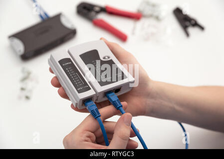 Man using a qualified cable performance tester. Teechnician measure a cables connected Stock Photo