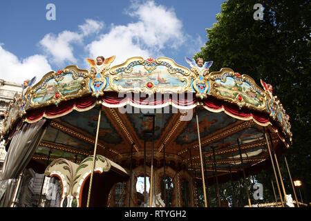 Colorful retro carousel in Rome. Children entertainment in park. Stock Photo