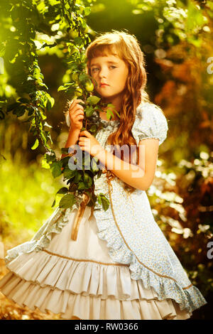 Adorable little girl in blooming apple tree Stock Photo
