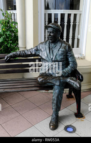 Statue of Sir Norman Wisdom sitting on a bench outside The Sefton Hotel ...