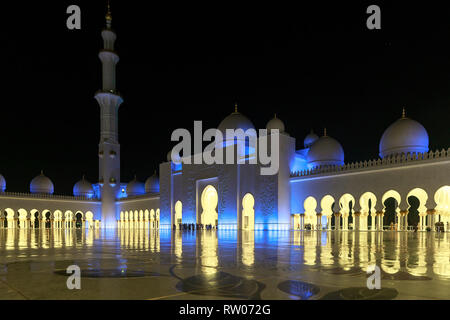 ABU DHABI, UAE, JANUARY 10, 2019: Magnificent view of the inner area of the mosque, beautifully illuminated with blue light in the evening Stock Photo