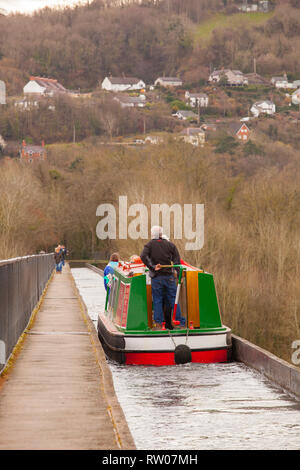 Man steering a narrow boat over the Pontcysyllte Aqueduct on the Llangollen canal  in North Wales above the river Dee built by Thomas Telford 1805 Stock Photo