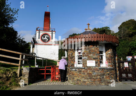 A visitor paying an entrance fee at the main visitorÕs entrance to the famous Laxey Wheel,  the world's greatest industrial water wheel. It is known f Stock Photo