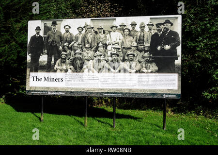 A large group photograph of the miners mounted on a visitorÕs display board, who used to work the mines near the Laxey WheelÕ located at Laxey, a few  Stock Photo