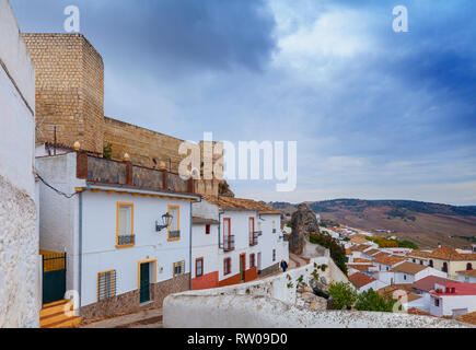 Old man below the 9th century, Berber Cañete la Real Castle towering above the town of Cañete la Real,  Province of Málaga, Andalusia, southern Spain. Stock Photo