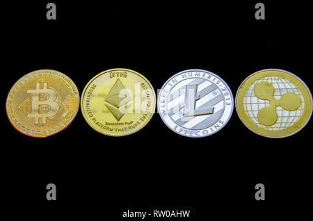bitcoin litecoin ethereum and ripple coins isolated on black background. Stock Photo
