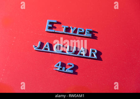 E Type Jaguar 4.2 , chrome letters on red background Stock Photo