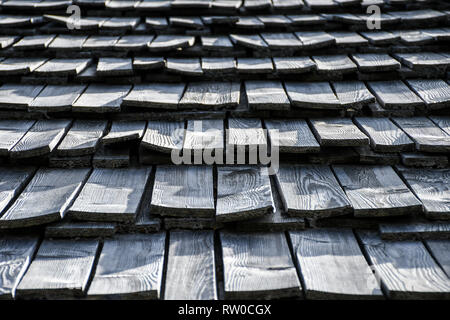 Very old grey curved wooden shingle roof texture Stock Photo