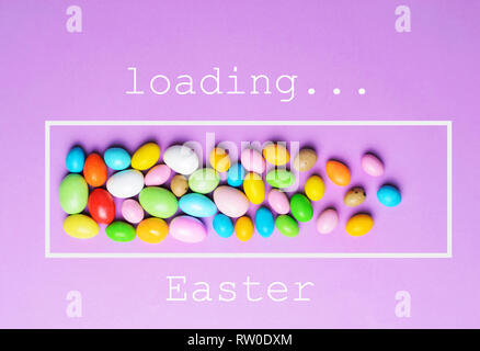 Easter Is Loading, Chocolate Eggs on Bright Background, Festive Easter Concept Stock Photo