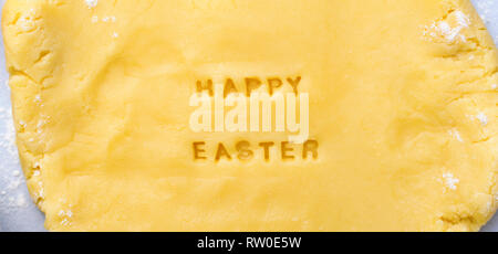 Easter Baking Background, Dough with Happy Easter Lettering, Festive Concept Stock Photo