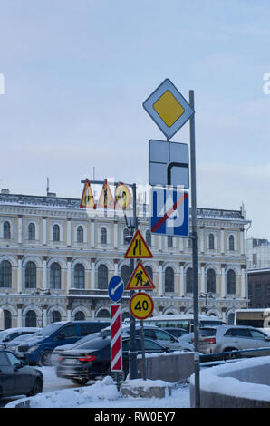 Many road signs warning of repairs, road narrowing and speed limit in the city Stock Photo