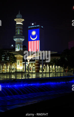 Masjid Jamek (Jamek Mosque) at night, Malaysian Flag in background. Kuala Lumpur, Malaysia. Stock Photo